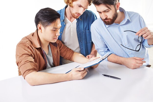 Serious co-workers checking the report