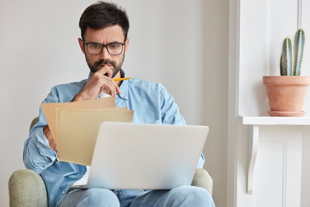 Serious concentrated businessman working at home