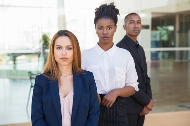 Serious confident female business leader posing in office