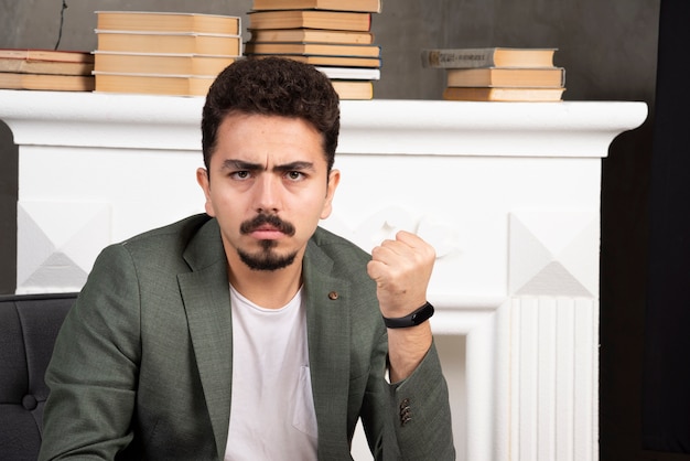 Serious confident man showing her fist.