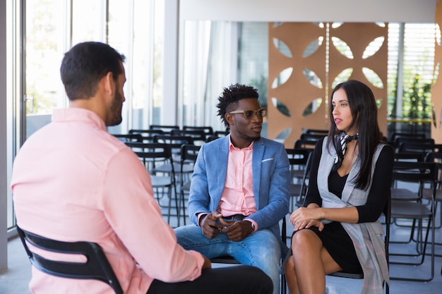 Serious coworkers discussing ongoing project together