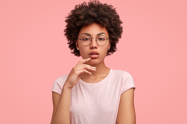 Serious dark skinned female with Afro haircut