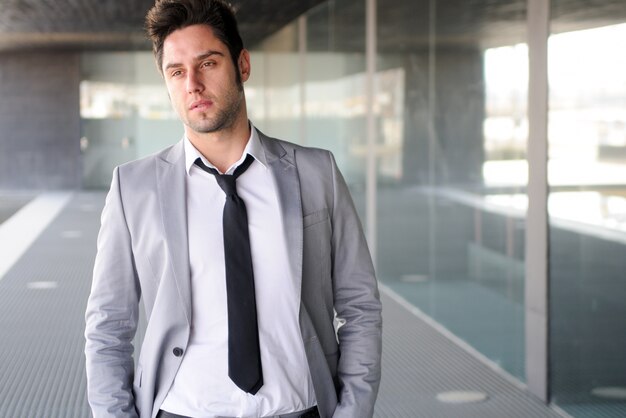 Serious employee with black tie and grey suit