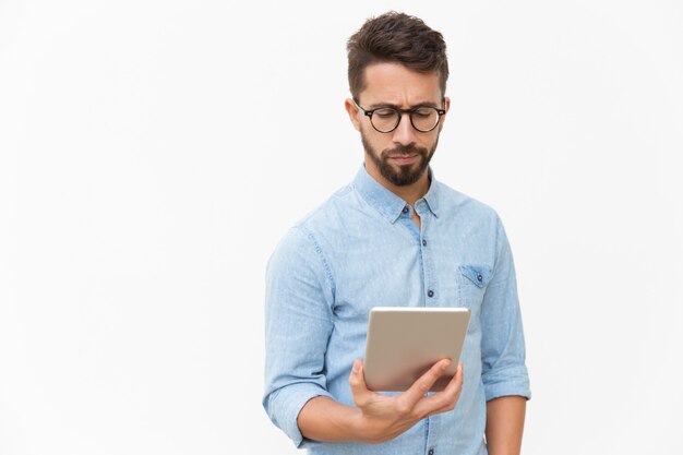 Serious entrepreneur checking email on tablet