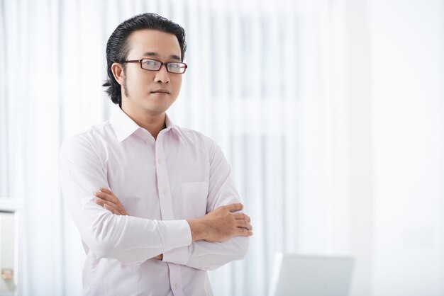 Serious ethnic businessman with arms crossed