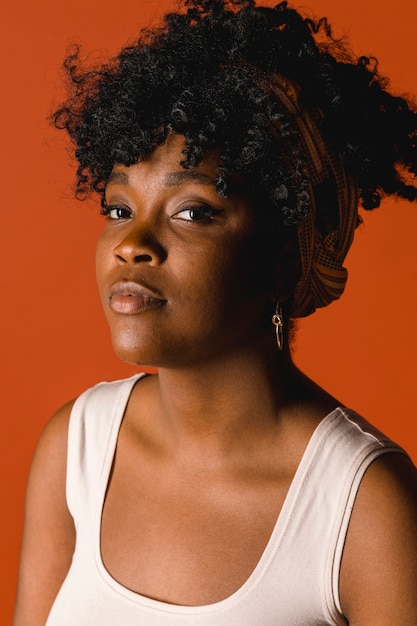 Free photo serious ethnic curly young female in t-shirt in studio