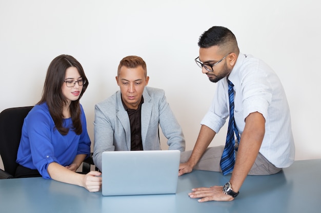 Serious executives connecting partner via laptop
