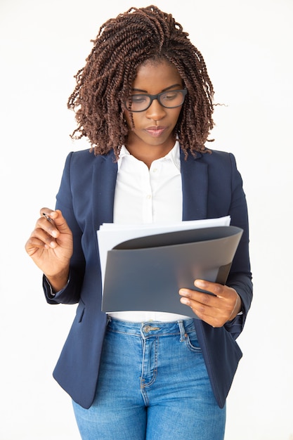 Serious expert wearing glasses, reading document