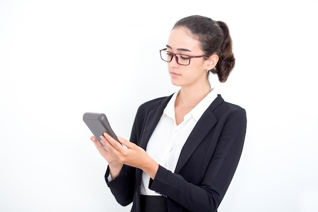 Serious female accountant counting on calculator