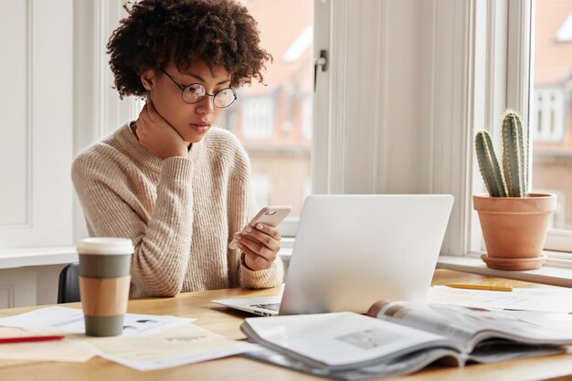 Serious female worker working at home