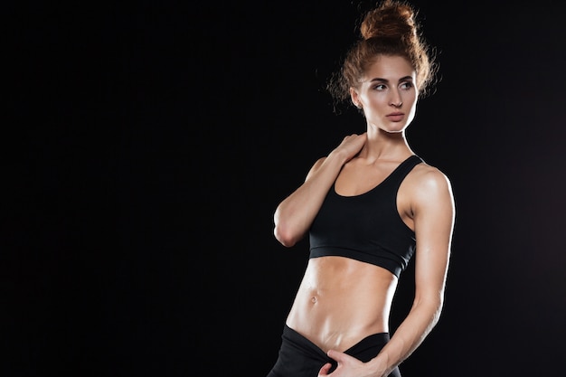 Serious Fitness woman posing in studio