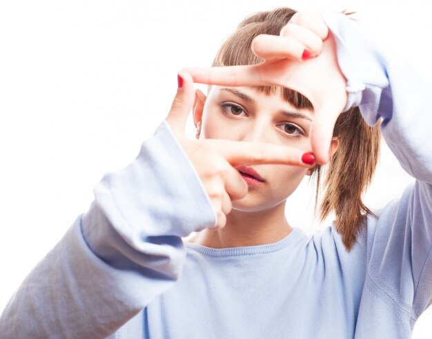 Serious girl doing a frame with her fingers