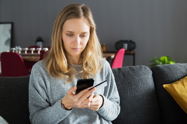 Serious girl using online bank