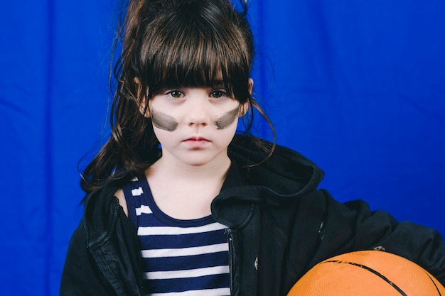 Serious girl with basketball ball