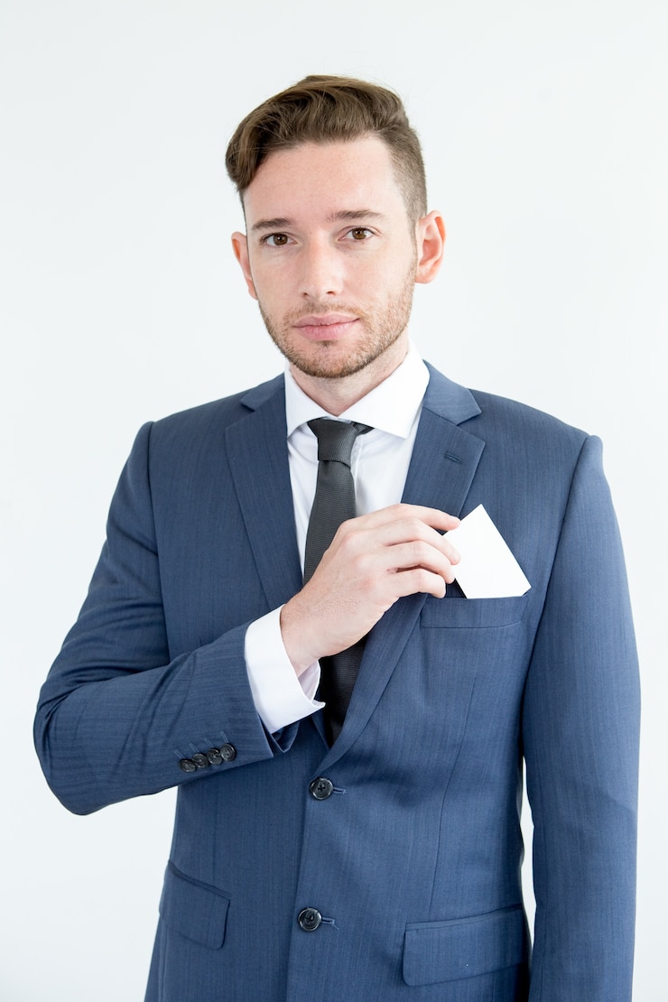 Free Photo serious handsome male executive holding blank card