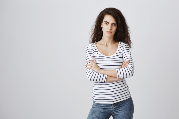 Serious-looking impatient woman cross arms chest and looking upset