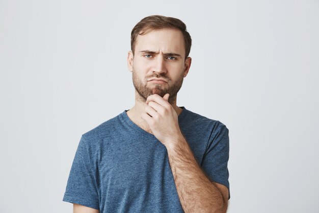 Serious-looking thoughtful man making decision