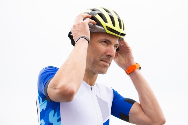 Serious male cyclist wearing helmet