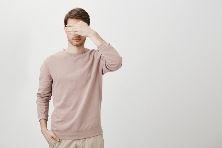 Free Photo serious man cover eyes, standing blindfolded