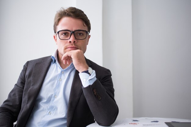 Serious man in eyeglasses confident in himself