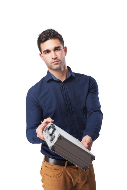 Serious man holding a metal briefcase