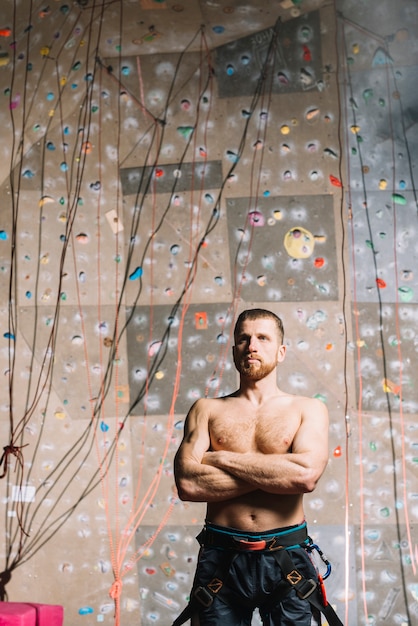 Serious man near climbing wall