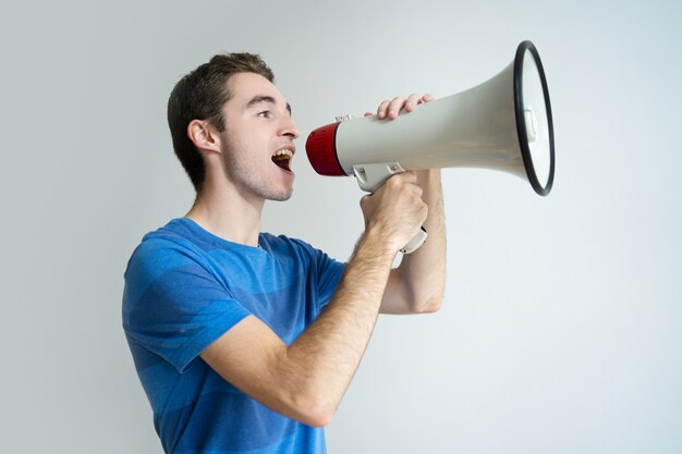 Serious man screaming into megaphone