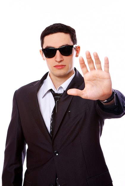 Free photo serious man in suit shows stop sign