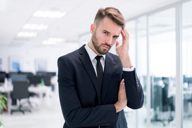 Serious man touching his head