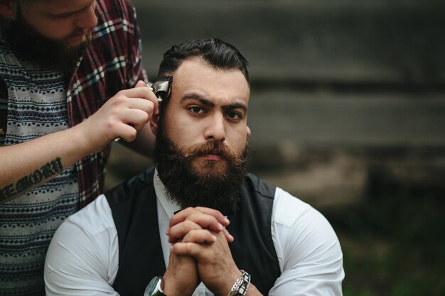 Serious man while shaving him