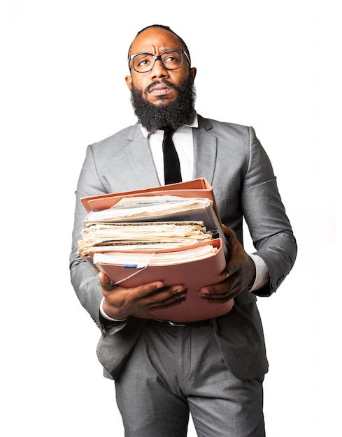 Serious man with lots of papers and folders