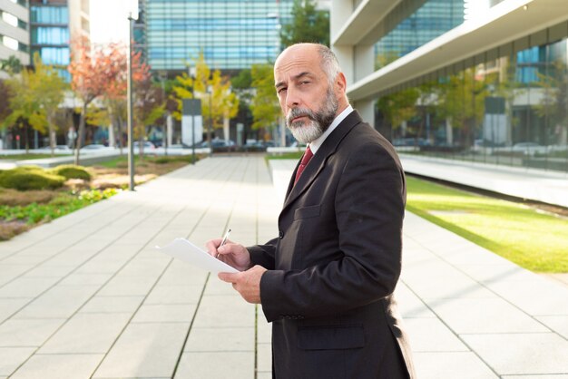 Serious mature businessman with papers