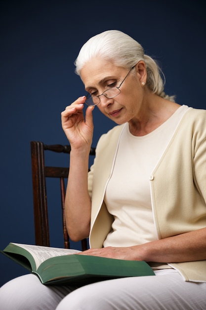 Serious old woman reading