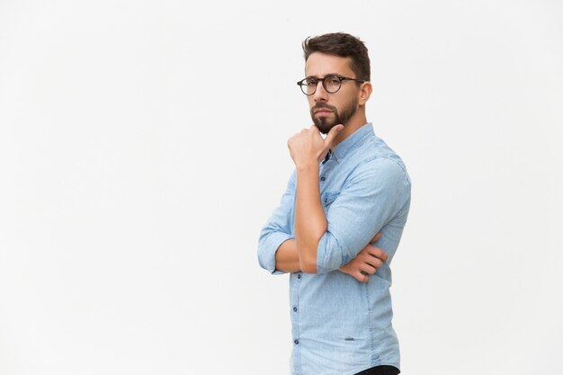 Serious pensive guy touching chin