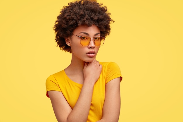 Serious pleasant looking hipster with Afro hairstyle