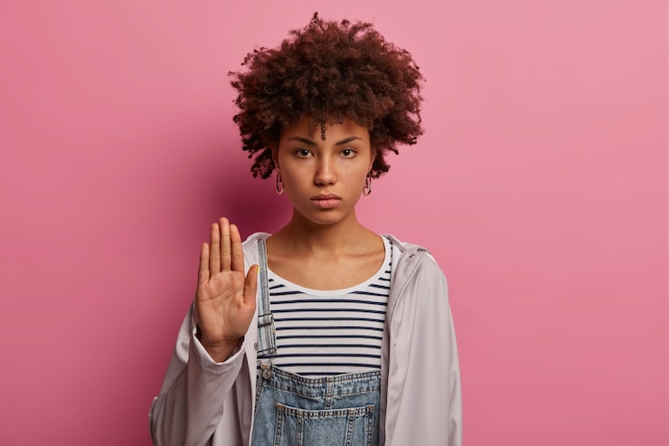 Free Photo serious strict woman shows stop gesture, raises palm forward