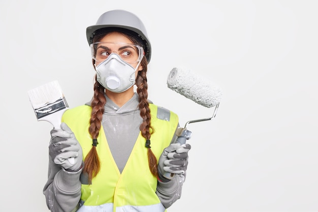 Serious thoughtful woman poses with repair tools 