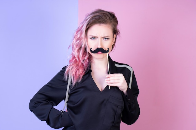 Free photo serious woman in black blouse and with fake mustache