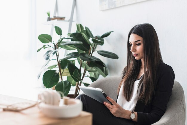 Serious woman browsing tablet