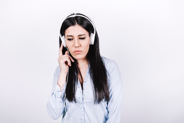 Serious woman listening to music