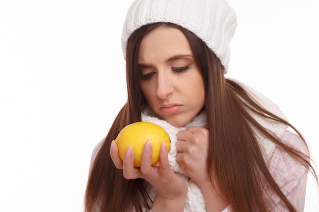 Serious woman looking at a lemon