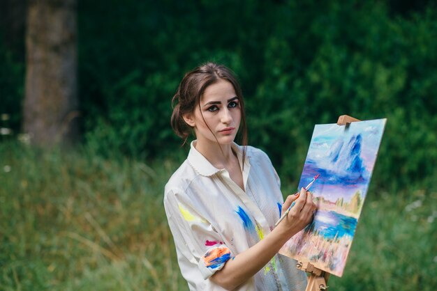 Serious woman painting a picture