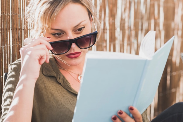 Free photo serious woman reading book