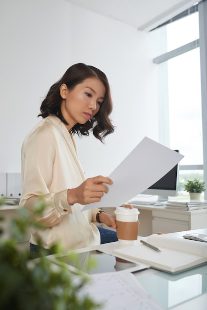 Free Photo serious woman reading contract
