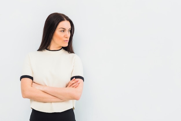 Serious woman standing with crossed arms