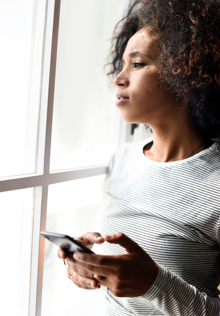 Free photo serious woman using a smartphone