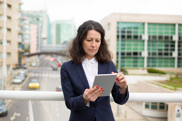 Serious woman using tablet pc