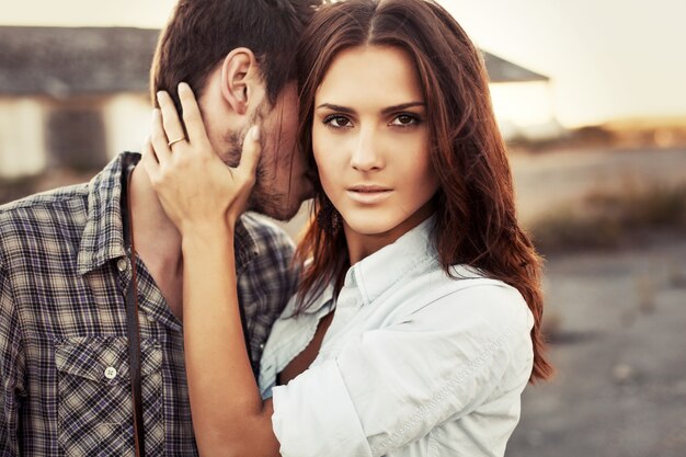 Serious woman with hand on her boyfriend's neck
