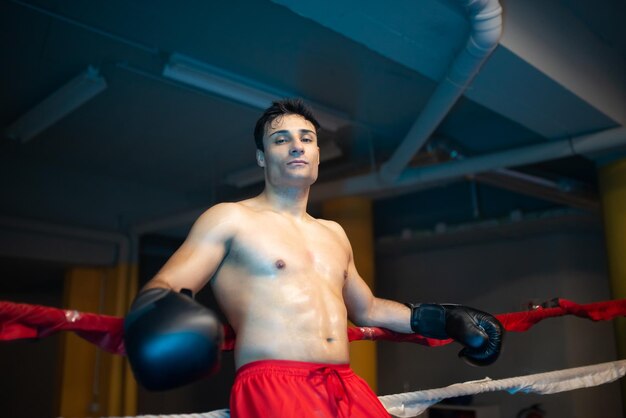 Serious young boxer resting during break