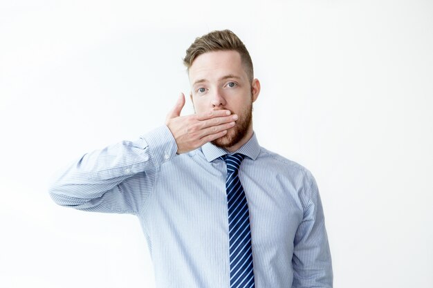 Serious Young Business Man Covering Mouth